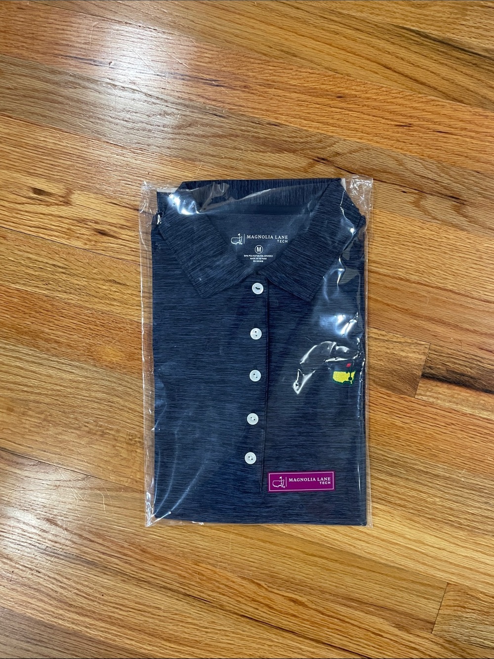Masters Magnolia women’s  Navy/black brindled  Polo with Small Green-Yellow Logo